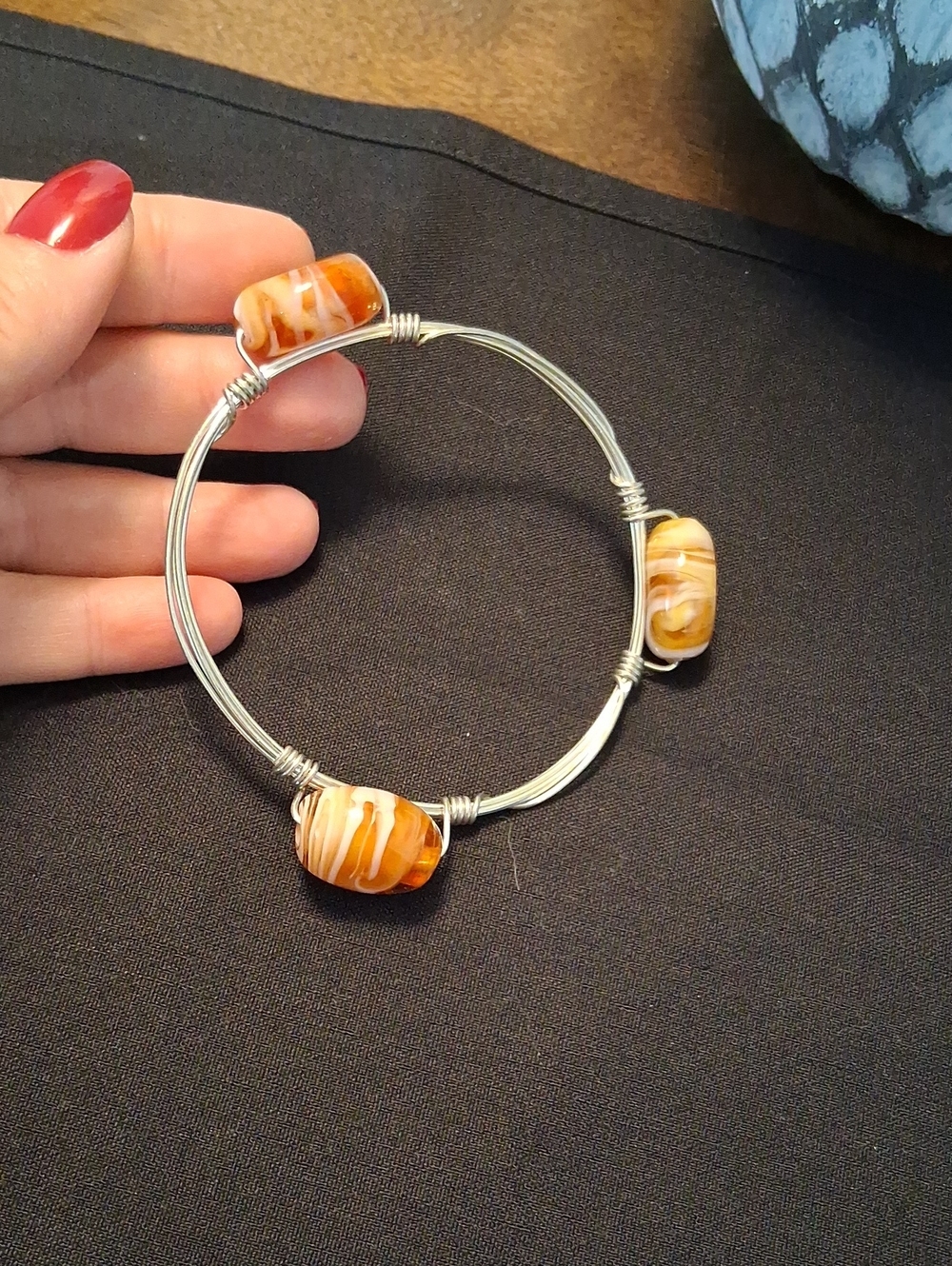 Handmade Silver Wire Bangle with Orange Swirl Glass Beads